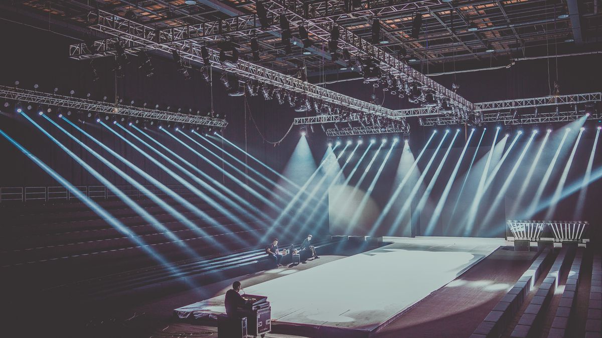A launch event stage lit up in front of an audience